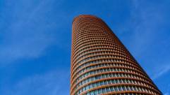 collaborative firm team, dynamic, brainstorming, photorealistic, professional setting with large format whiteboard, highly detailed, actively discussing, crystal clear imagery, muted professional colors, natural office lighting, shot with a 50mm lens.